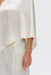 CRUSH ONE SHOULDER CAPE | CREAM - THIRD FORM
